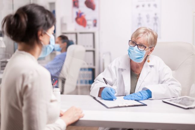 Doctor wearing protection mask against covid